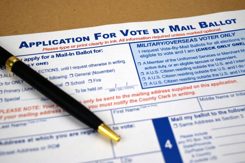 Vote by mail envelope with pen.