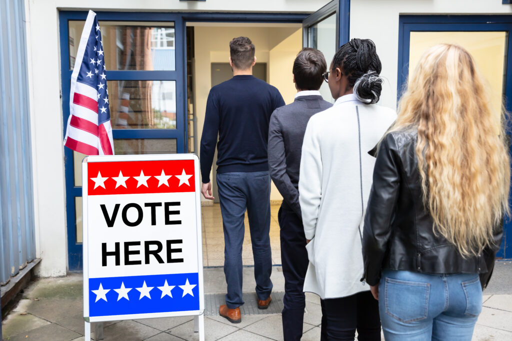 Group Of Young People Standing At The Entrance Of Voting Room 